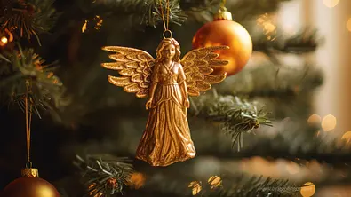 Goldener Engel hängt in einem Weihnachtsbaum - Foto: Anna / AdobeStock