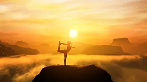 Frau macht in den Bergen eine Yoga-Pose im Sonnenuntergang - Foto: Photocreo Bednarek / AdobeStock Frau macht in den Bergen eine Yoga-Pose im Sonnenuntergang - Foto: Photocreo Bednarek / AdobeStock