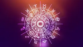 Ein Horoskopkreis mit verschiedenen Symbolen vor einem bunten Hintergrund  - Foto: Surasak Suwanmake/iStock