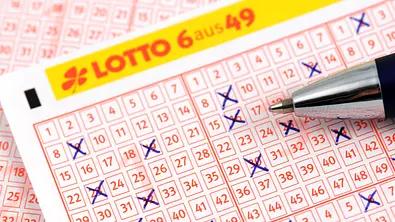 Lottozettel mit gesetzten Kreuzchen und Stift - Foto: iStock/hsvrs