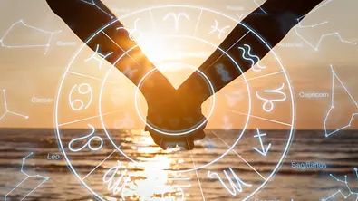 Sternzeichenradix vor dem Hintergrund von zwei Menschen, die Händchen halten - Foto: iStock/AndreyPopov