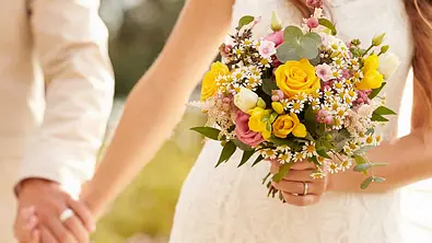 Ein Hochzeitspaar hält sich an den Händen - Foto: monkeybusinessimages/iStock Ein Hochzeitspaar hält sich an den Händen - Foto: monkeybusinessimages/iStock